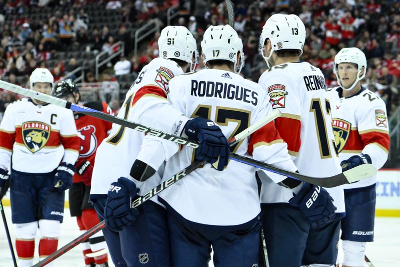 Oct 16, 2023; Newark, New Jersey, USA; Florida Panthers center Sam Reinhart (13) celebrates with teammates after scoring a goal against the New Jersey Devils during the third period at Prudential Center. Mandatory Credit: John Jones-USA TODAY Sports