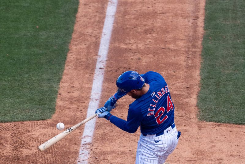 Mar 9, 2024; Mesa, Arizona, USA; Chicago Cubs outfielder Cody Bellinger (24) lines out against the Colorado Rockies in the fifth inning during a spring training game at Sloan Park. Mandatory Credit: Allan Henry-USA TODAY Sports