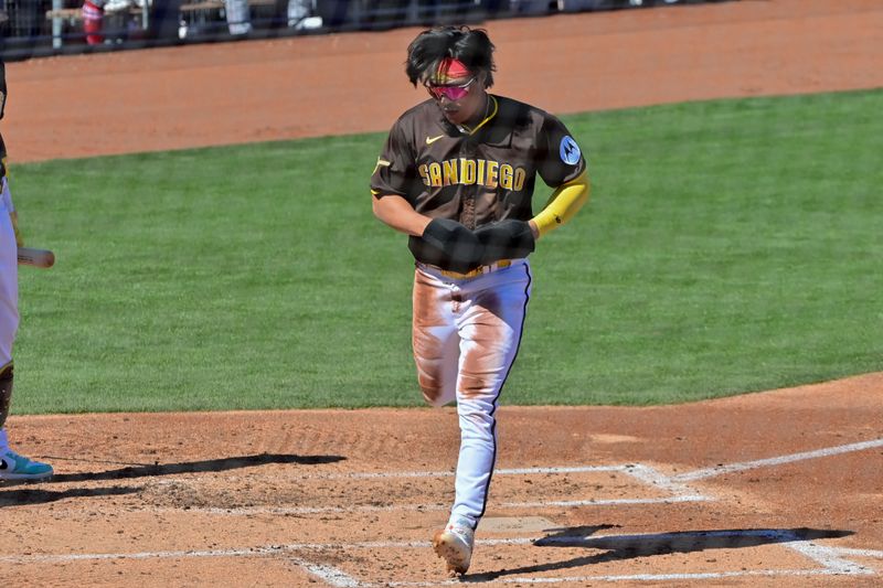 Mar 1, 2024; Peoria, Arizona, USA; San Diego Padres shortstop Ha-Seong Kim (7) scores in the second inning against the Los Angeles Angels during a spring training game at Peoria Sports Complex. Mandatory Credit: Matt Kartozian-USA TODAY Sports