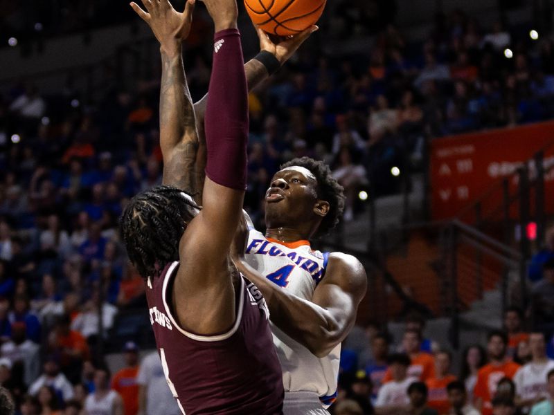 Jan 24, 2024; Gainesville, Florida, USA; Mississippi State Bulldogs forward Cameron Matthews (4) attempts to block a shot from Florida Gators forward Tyrese Samuel (4) during the second half at Exactech Arena at the Stephen C. O'Connell Center. Mandatory Credit: Matt Pendleton-USA TODAY Sports