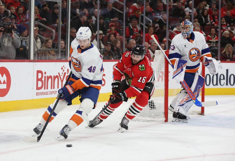 Dec 30, 2025; Chicago, Illinois, USA; New York Islanders defenseman Matthew Schaefer (48) and Chicago Blackhawks center Jason Dickinson (16) battle for control of the puck during the first period at United Center. Mandatory Credit: Talia Sprague-Imagn Images