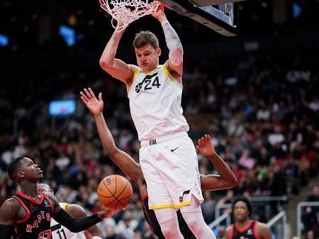 TORONTO, ON - DECEMBER 23: Walker Kessler #24 of the Utah Jazz dunks against Dennis Schroder #17 of the Toronto Raptors during the second half of their basketball game at the Scotiabank Arena on December 23, 2023 in Toronto, Ontario, Canada. NOTE TO USER: User expressly acknowledges and agrees that, by downloading and/or using this Photograph, user is consenting to the terms and conditions of the Getty Images License Agreement. (Photo by Mark Blinch/Getty Images)