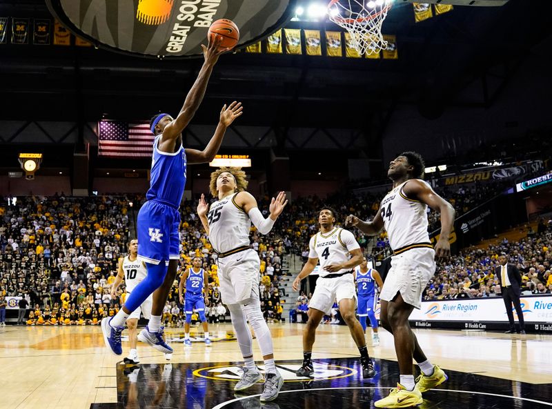 Dec 28, 2022; Columbia, Missouri, USA; Kentucky Wildcats forward Oscar Tshiebwe (34) shoots against Missouri Tigers forward Noah Carter (35) and guard Kobe Brown (24) during the first half at Mizzou Arena. Mandatory Credit: Jay Biggerstaff-USA TODAY Sports