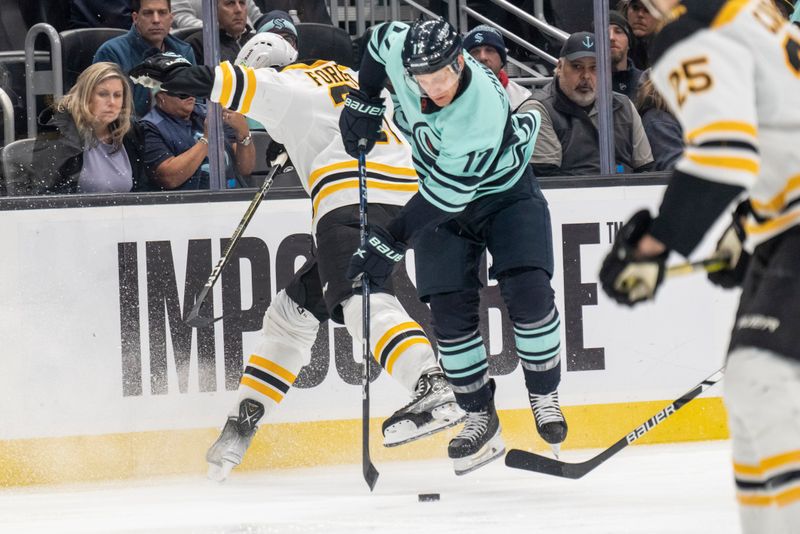 Feb 23, 2023; Seattle, Washington, USA; Seattle Kraken forward Jaden Schwartz (17) and Boston Bruins defenseman Derek Forbort (28) battle for the puck during the third period at Climate Pledge Arena. Mandatory Credit: Stephen Brashear-USA TODAY Sports