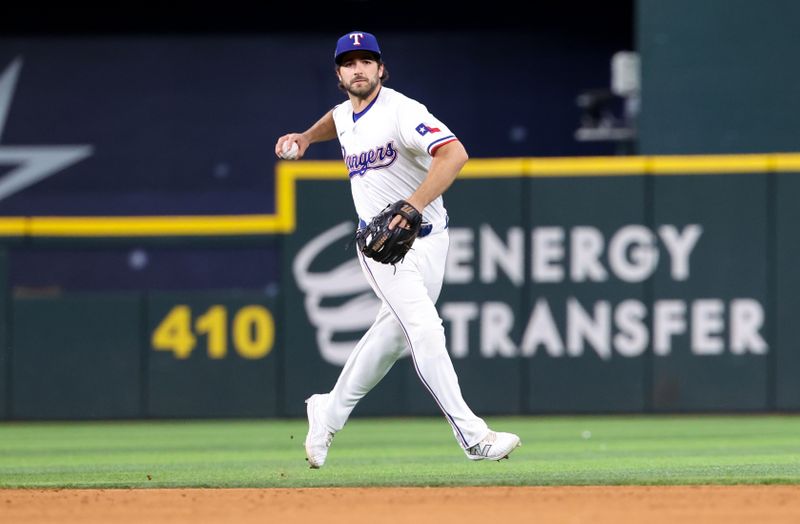 Jul 2, 2024; Arlington, Texas, USA;  Texas Rangers shortstop Josh Smith (8) throws to first base for an out during the sixth inning against the San Diego Padres at Globe Life Field. Mandatory Credit: Kevin Jairaj-USA TODAY Sports