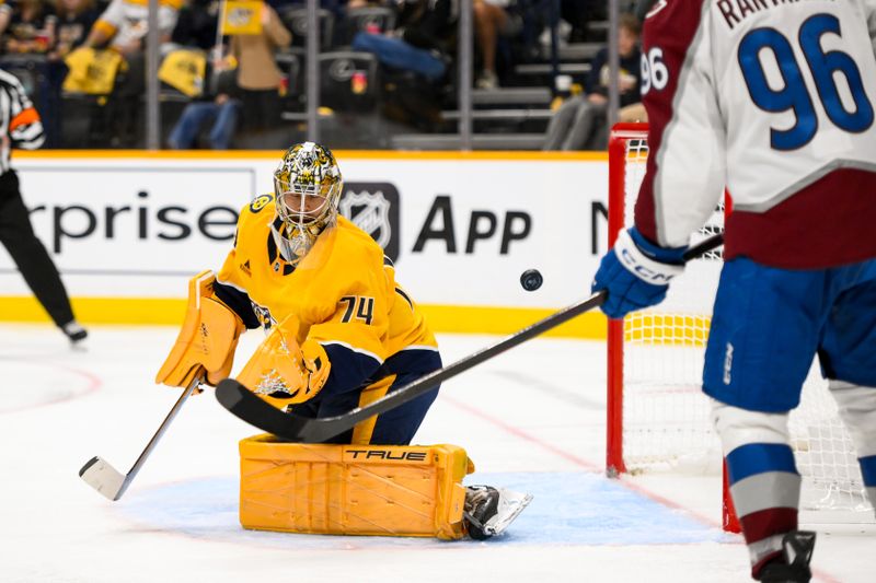 Nov 2, 2024; Nashville, Tennessee, USA;  Colorado Avalanche defenseman Cale Makar (8) scores past Nashville Predators goaltender Juuse Saros (74) during the second period at Bridgestone Arena. Mandatory Credit: Steve Roberts-Imagn Images