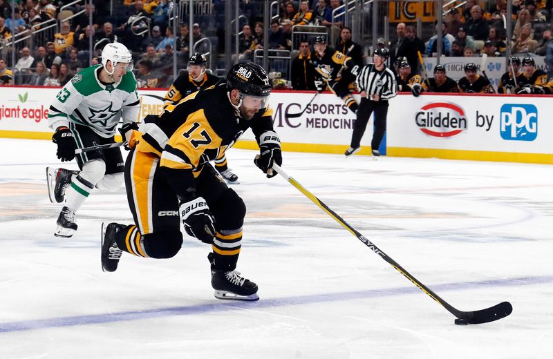 Oct 24, 2023; Pittsburgh, Pennsylvania, USA; Pittsburgh Penguins right wing Bryan Rust (17) breaks up ice with the puck against the Dallas Stars during the third period at PPG Paints Arena. Dallas won 4-1. Mandatory Credit: Charles LeClaire-USA TODAY Sports