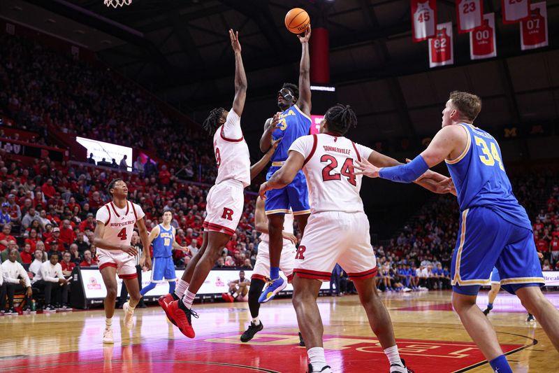 Jan 13, 2025; Piscataway, New Jersey, USA; UCLA Bruins guard Eric Dailey Jr. (3) shoots the ball asRutgers Scarlet Knights forward Dylan Grant (9) defends during the first half at Jersey Mike's Arena. Mandatory Credit: Vincent Carchietta-Imagn Images