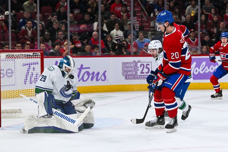 Nov 12, 2023; Montreal, Quebec, CAN; Vancouver Canucks goalie Casey DeSmith (29) makes a save against Montreal Canadiens left wing Juraj Slafkovsky (20) during the second period at Bell Centre. Mandatory Credit: David Kirouac-USA TODAY Sports