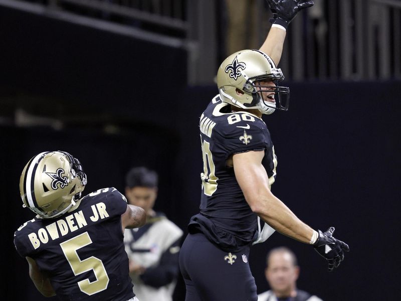 New Orleans Saints tight end Jimmy Graham (80) celebrates with wide receiver Lynn Bowden Jr. (5) during an NFL football game against the New York Giants, Sunday, Dec. 17, 2023, in New Orleans. (AP Photo/Tyler Kaufman)