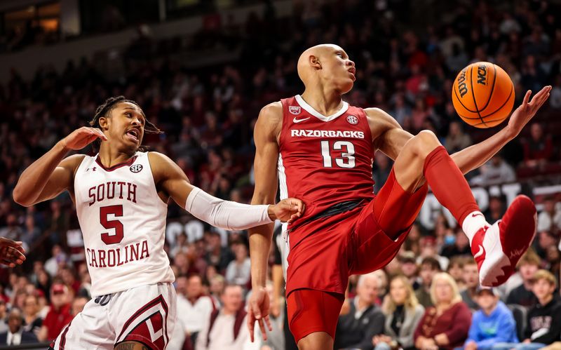 Feb 4, 2023; Columbia, South Carolina, USA; Arkansas Razorbacks guard Jordan Walsh (13) and South Carolina Gamecocks guard Meechie Johnson (5) battle for a rebound in the first half at Colonial Life Arena. Mandatory Credit: Jeff Blake-USA TODAY Sports