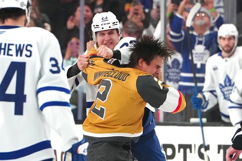 Mar 5, 2025; Las Vegas, Nevada, USA; Toronto Maple Leafs left wing Matthew Knies (23) fights Vegas Golden Knights defenseman Zach Whitecloud (2) during the first period at T-Mobile Arena. Mandatory Credit: Stephen R. Sylvanie-Imagn Images