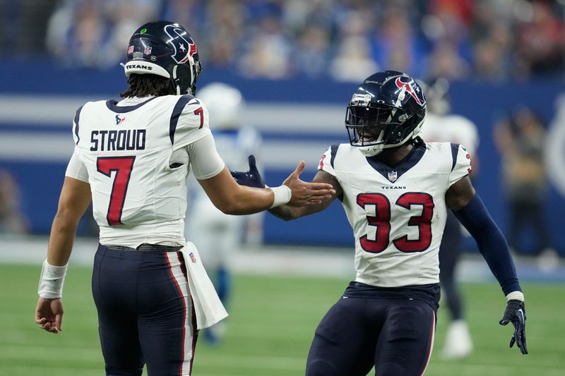 Houston Texans quarterback C.J. Stroud (7) celebrates his touchdown pass with running back Dare Ogunbowale (33) during the first half of an NFL football game against the Indianapolis Colts, Saturday, Jan. 6, 2024, in Indianapolis. (AP Photo/Michael Conroy)