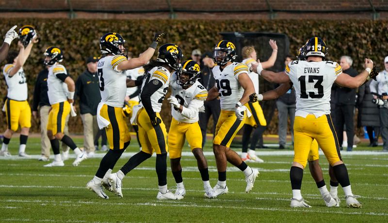 Nov 4, 2023; Chicago, Illinois, USA; The Iowa Hawkeyes celebrate their win against the Northwestern Wildcats at Wrigley Field. Mandatory Credit: David Banks-USA TODAY Sports