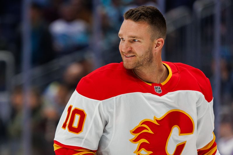 Oct 19, 2024; Seattle, Washington, USA; Calgary Flames center Jonathan Huberdeau (10) warms up before the game against the Seattle Kraken at Climate Pledge Arena. Mandatory Credit: Caean Couto-Imagn Images