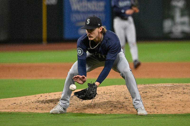 Sep 6, 2024; St. Louis, Missouri, USA; Seattle Mariners starting pitcher Bryce Miller (50) fields a ground ball by the St. Louis Cardinals in the fifth inning at Busch Stadium. Mandatory Credit: Joe Puetz-Imagn Images