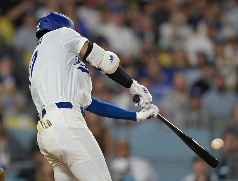 Sep 17, 2025; Los Angeles, California, USA;  Los Angeles Dodgers designated hitter Shohei Ohtani (17) hits his 51st home run of the season in the eighth inning against the Philadelphia Phillies at Dodger Stadium. Mandatory Credit: Jayne Kamin-Oncea-Imagn Images