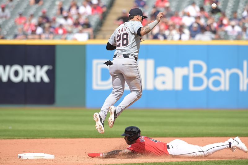 May 8, 2024; Cleveland, Ohio, USA; Cleveland Guardians shortstop Brayan Rocchio (4) steals second as Detroit Tigers shortstop Javier Baez (28) jumps for the throw during the eighth inning at Progressive Field. Mandatory Credit: Ken Blaze-USA TODAY Sports