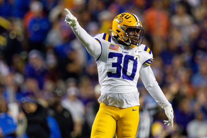 Nov 11, 2023; Baton Rouge, Louisiana, USA;  LSU Tigers linebacker Greg Penn III (30) reacts to a fumble recovery by LSU Tigers safety Javien Toviano (25) against the Florida Gators during the first half at Tiger Stadium. Mandatory Credit: Stephen Lew-USA TODAY Sports