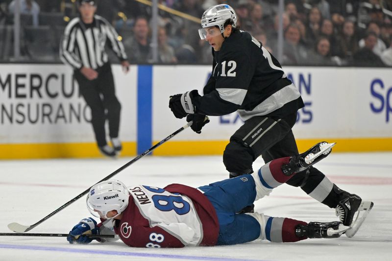 Oct 7, 2025; Los Angeles, California, USA;  Colorado Avalanche center Martin Necas (88) gets tripped up by Los Angeles Kings left wing Trevor Moore (12) during the first period at Crypto.com Arena. Mandatory Credit: Jayne Kamin-Oncea-Imagn Images