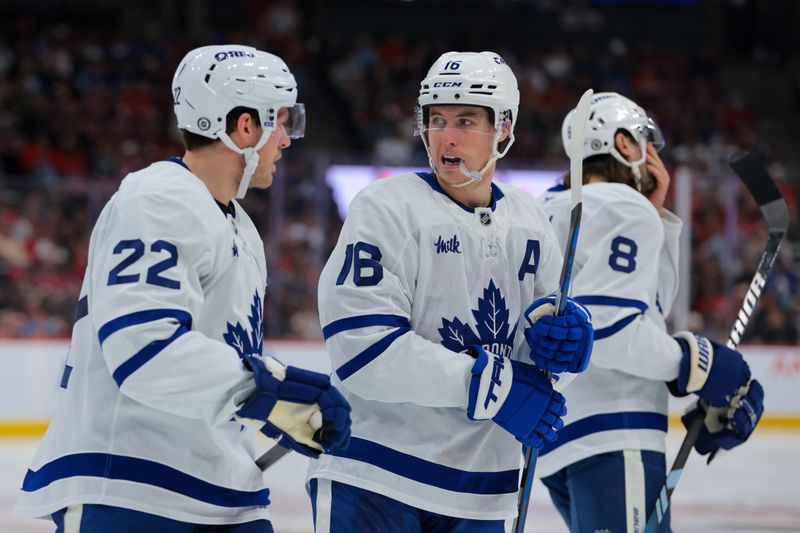 Nov 27, 2024; Sunrise, Florida, USA; Toronto Maple Leafs right wing Mitch Marner (16) talks to defenseman Jake McCabe (22) against the Florida Panthers during the second period at Amerant Bank Arena. Mandatory Credit: Sam Navarro-Imagn Images