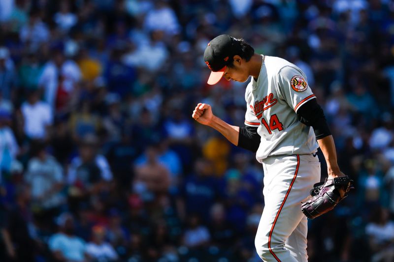 Aug 13, 2023; Seattle, Washington, USA; Baltimore Orioles relief pitcher Shintaro Fujinami (14) reacts after getting the final out of the tenth inning to secure a 5-3 victory against the Seattle Mariners at T-Mobile Park. Mandatory Credit: Joe Nicholson-USA TODAY Sports