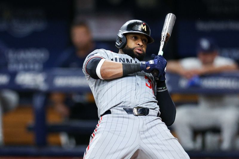 Sep 2, 2024; St. Petersburg, Florida, USA; Minnesota Twins first baseman Carlos Santana (30) reacts to an inside pitch against the Tampa Bay Rays in the seventh inning at Tropicana Field. Mandatory Credit: Nathan Ray Seebeck-USA TODAY Sports