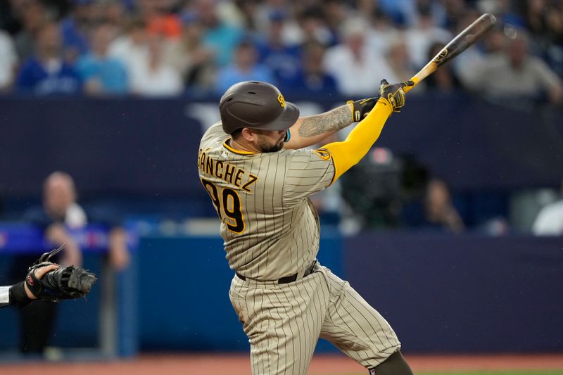 Jul 18, 2023; Toronto, Ontario, CAN; San Diego Padres catcher Gary Sanchez (99) hits a solo home run against the Toronto Blue Jays during the fifth inning at Rogers Centre. Mandatory Credit: John E. Sokolowski-USA TODAY Sports