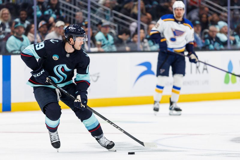 Oct 8, 2024; Seattle, Washington, USA; Seattle Kraken left wing Jared McCann (19) skates with the puck against the St. Louis Blues during the second period at Climate Pledge Arena. Mandatory Credit: Caean Couto-Imagn Images