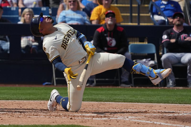 Mar 16, 2025; Phoenix, Arizona, USA; Milwaukee Brewers catcher William Contreras (24) falls to the ground after missing a pitch against the Cleveland Guardians in the third inning at American Family Fields of Phoenix. Mandatory Credit: Rick Scuteri-Imagn Images