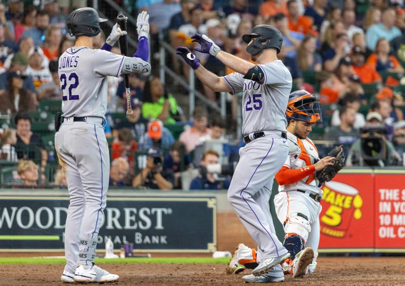 Jul 5, 2023; Houston, Texas, USA; Colorado Rockies designated hitter C.J. Cron (25) celebrates with first baseman Nolan Jones (22) after hitting a home run against the Houston Astros in the sixth inning at Minute Maid Park. Mandatory Credit: Thomas Shea-USA TODAY Sports