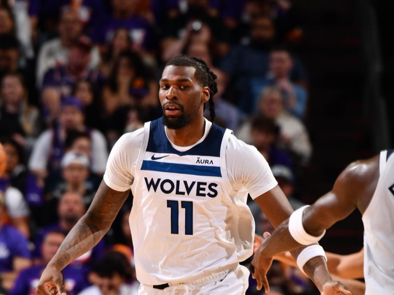 PHOENIX, AZ - APRIL 26:  Naz Reid #11 of the Minnesota Timberwolves high fives teammate during the game against the Phoenix Suns during Round 1 Game 3 of the 2024 NBA Playoffs on April 26, 2024 at Footprint Center in Phoenix, Arizona. NOTE TO USER: User expressly acknowledges and agrees that, by downloading and or using this photograph, user is consenting to the terms and conditions of the Getty Images License Agreement. Mandatory Copyright Notice: Copyright 2024 NBAE (Photo by Barry Gossage/NBAE via Getty Images)