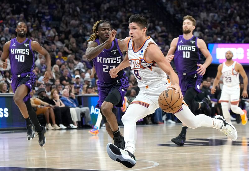 SACRAMENTO, CALIFORNIA - APRIL 12: Grayson Allen #8 of the Phoenix Suns looks to drive to the basket past Keon Ellis #23 of the Sacramento Kings during the first half of an NBA basketball game at Golden 1 Center on April 12, 2024 in Sacramento, California. NOTE TO USER: User expressly acknowledges and agrees that, by downloading and or using this photograph, User is consenting to the terms and conditions of the Getty Images License Agreement. (Photo by Thearon W. Henderson/Getty Images)