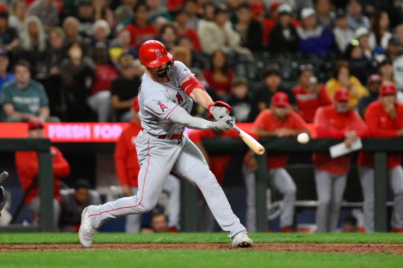 Sep 11, 2023; Seattle, Washington, USA; Los Angeles Angels left fielder Randal Grichuk (15) hits an RBI single against the Seattle Mariners during the eleventh inning at T-Mobile Park. Mandatory Credit: Steven Bisig-USA TODAY Sports