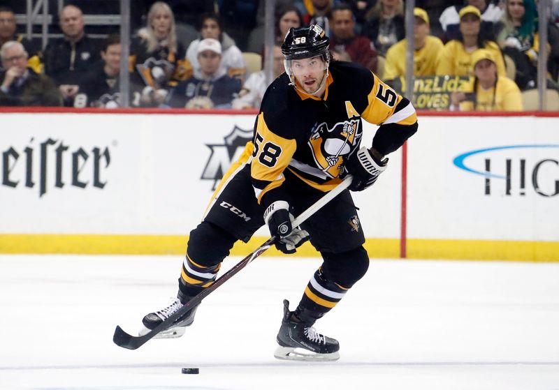 Feb 7, 2023; Pittsburgh, Pennsylvania, USA;  Pittsburgh Penguins defenseman Kris Letang (58) skates up ice with he puck against the Colorado Avalanche during the third period at PPG Paints Arena. The Penguins won 2-1 in overtime. Mandatory Credit: Charles LeClaire-USA TODAY Sports