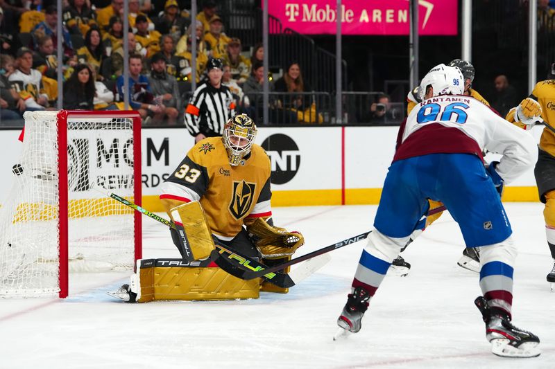 Apr 14, 2024; Las Vegas, Nevada, USA; Colorado Avalanche right wing Mikko Rantanen (96) deflects the puck past Vegas Golden Knights goaltender Adin Hill (33) during the second period at T-Mobile Arena. Mandatory Credit: Stephen R. Sylvanie-USA TODAY Sports