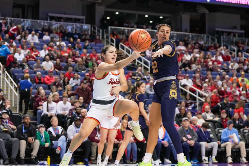 Mar 9, 2024; Greensboro, NC, USA; Virginia Tech Hokies guard Georgia Amoore (5) passes the ball around Notre Dame Fighting Irish forward Kylee Watson (22) in the first half at Greensboro Coliseum. Mandatory Credit: David Yeazell-USA TODAY Sports