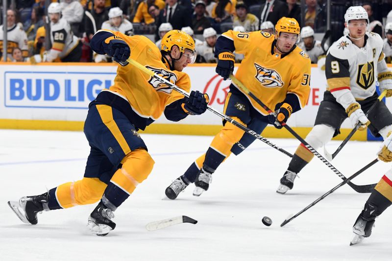 Mar 26, 2024; Nashville, Tennessee, USA; Nashville Predators defenseman Jeremy Lauzon (3) breaks his stick on a shot during the first period against the Vegas Golden Knights at Bridgestone Arena. Mandatory Credit: Christopher Hanewinckel-USA TODAY Sports