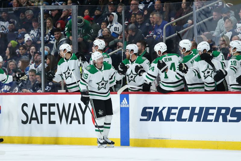 Nov 11, 2023; Winnipeg, Manitoba, CAN;  Dallas Stars forward Matt Duchene (95) is congratulated by his teammates on his goal against the Winnipeg Jets during the second period at Canada Life Centre. Mandatory Credit: Terrence Lee-USA TODAY Sports