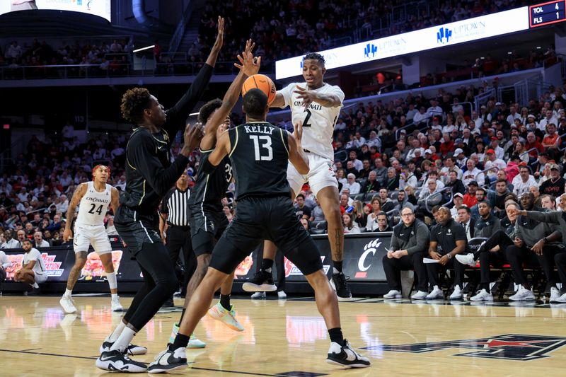 Feb 4, 2023; Cincinnati, Ohio, USA;  Cincinnati Bearcats guard Landers Nolley II (2) loses the ball as he is guarded by UCF Knights forward Taylor Hendricks (back) in the first half at Fifth Third Arena. Mandatory Credit: Aaron Doster-USA TODAY Sports