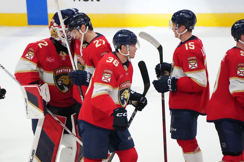 Oct 19, 2024; Sunrise, Florida, USA;  Florida Panthers center Eetu Luostarinen (27) congratulates goaltender Sergei Bobrovsky (72) following an overtime victory against the Vegas Golden Knights at Amerant Bank Arena. Mandatory Credit: Jim Rassol-Imagn Images