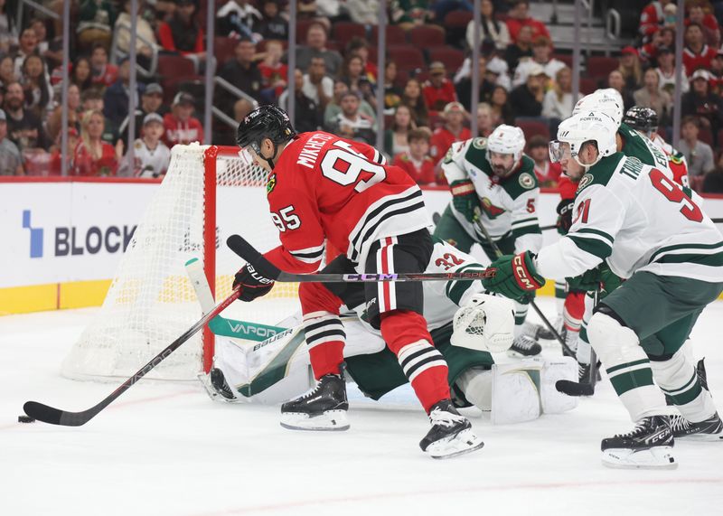 Oct 3, 2025; Chicago, Illinois, USA; Chicago Blackhawks right wing Ilya Mikheyev (95) drives to the goal past Minnesota Wild goaltender Filip Gustavsson (32) during the first period at United Center. Mandatory Credit: Talia Sprague-Imagn Images
