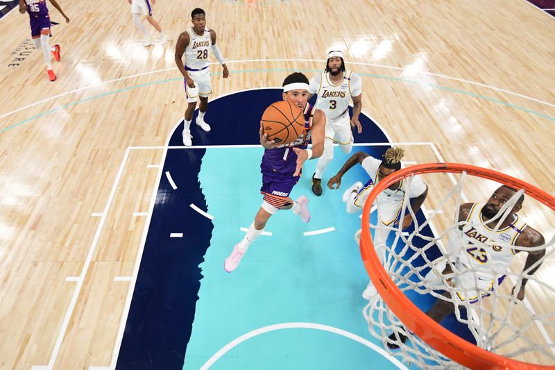 LOS ANGELES, CA - OCTOBER 6: Devin Booker #1 of the Phoenix Suns drives to the basket during the game against the Los Angeles Lakers on October 6, 2024 at Acrisure Arena in Palm Springs, California. NOTE TO USER: User expressly acknowledges and agrees that, by downloading and/or using this Photograph, user is consenting to the terms and conditions of the Getty Images License Agreement. Mandatory Copyright Notice: Copyright 2024 NBAE (Photo by Adam Pantozzi/NBAE via Getty Images)