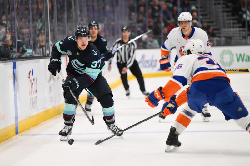 Nov 16, 2024; Seattle, Washington, USA; Seattle Kraken center Yanni Gourde (37) advances the puck against the New York Islanders during the third period at Climate Pledge Arena. Mandatory Credit: Steven Bisig-Imagn Images