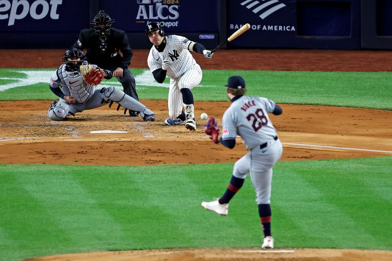 Oct 15, 2024; Bronx, New York, USA; New York Yankees shortstop Anthony Volpe (11) hits a single during the second inning against the Cleveland Guardians in game two of the ALCS for the 2024 MLB Playoffs at Yankee Stadium. Mandatory Credit: Brad Penner-Imagn Images