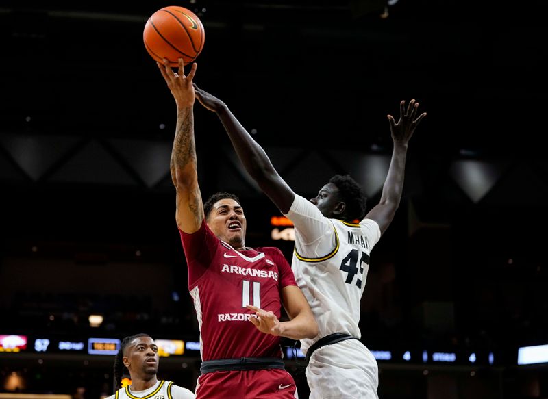 Jan 31, 2024; Columbia, Missouri, USA; Arkansas Razorbacks forward Jalen Graham (11) shoots against Missouri Tigers center Mabor Majak (45) during the second half at Mizzou Arena. Mandatory Credit: Jay Biggerstaff-USA TODAY Sports