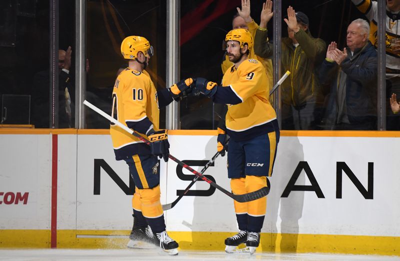 Dec 7, 2023; Nashville, Tennessee, USA; Nashville Predators left wing Filip Forsberg (9) is congratulated by center Colton Sissons (10) after a goal during the second period against the Tampa Bay Lightning at Bridgestone Arena. Mandatory Credit: Christopher Hanewinckel-USA TODAY Sports