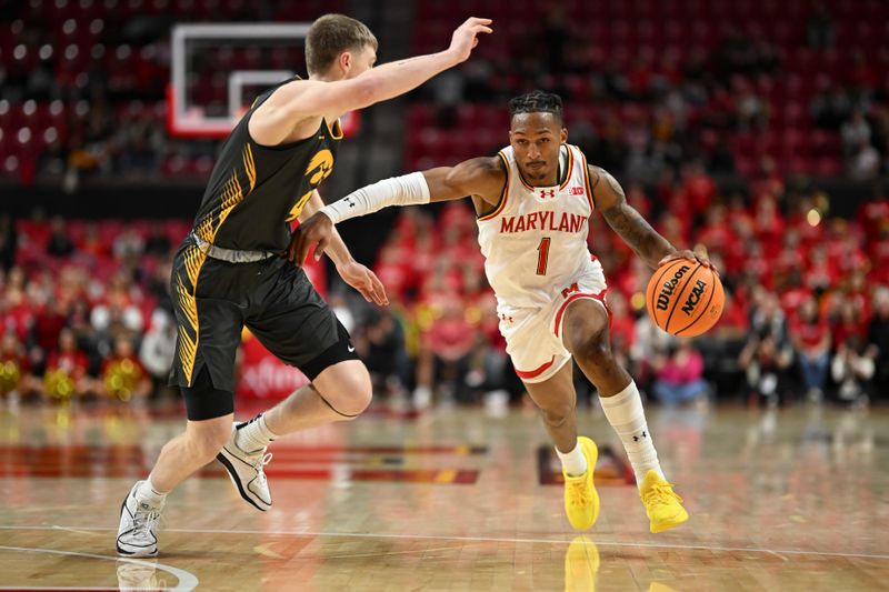 Feb 14, 2024; College Park, Maryland, USA;  Maryland Terrapins guard Jahmir Young (1) drives to the basket on Iowa Hawkeyes guard Josh Dix (4) during the second half at Xfinity Center. Mandatory Credit: Tommy Gilligan-USA TODAY Sports