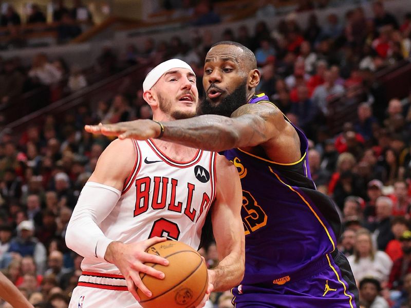 CHICAGO, ILLINOIS - DECEMBER 20: Alex Caruso #6 of the Chicago Bulls drives to the basket against LeBron James #23 of the Los Angeles Lakers during the second half at the United Center on December 20, 2023 in Chicago, Illinois. NOTE TO USER: User expressly acknowledges and agrees that, by downloading and or using this photograph, User is consenting to the terms and conditions of the Getty Images License Agreement.  (Photo by Michael Reaves/Getty Images)