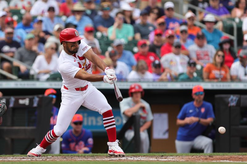 Mar 1, 2024; Jupiter, Florida, USA; St. Louis Cardinals second baseman Jose Fermin (15) hits a single against the New York Mets during the fourth inning at Roger Dean Chevrolet Stadium. Mandatory Credit: Sam Navarro-USA TODAY Sports